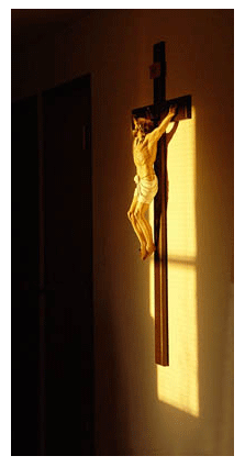 Morning sun shines on the cloister crucifix in the Moanstery crucifix in the morning sun