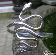 Smooth curves of Sterling Silver to create a fluid snake armlet.