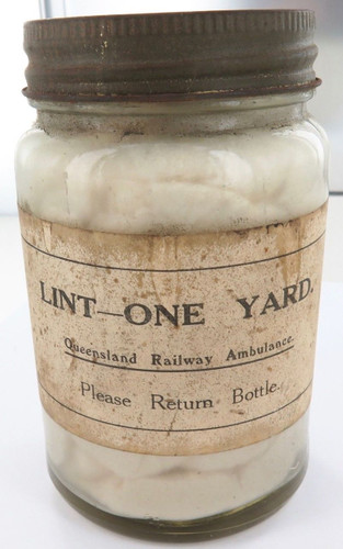 Rarer early 1900s QLD Railway Ambulance “Lint, One Yard” glass jar + contents