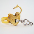 Gold padlock ring really opens and closes.  Comes with non-working key