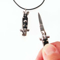 YOU gNeek's YOU Are Sooo Dangerous Switchblade Necklace shown here in the flicked open position and closed (on your necklace) position.