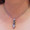 YOU gNeek's Tiny Working Switchblade Necklace shown worn high on the neck on a 2.4mm stainless steel ball chain necklace.