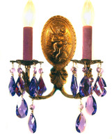 A pair of antique brass sconces draped with purple STRASS crystal