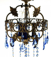 Crown shaped antique brass chandelier draped in rich blue STRASS Swarovski crystal