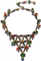 This is a larger version of the popular v-necklace with a more spacious effect.  All designed on gold filled metal and adjustable to desired length on your neck.  Packed full of vintage and discontinued SWAROVSKI ELEMENTS. The main colors include Peridot, Special Effects, Salmon, Golden Shadow and Green Tourmaline.