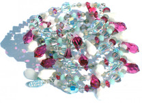 7 layer coil bracelet on memory wire and finished in sterling silver from the guanahani collection.  All Swarovski elements including rare and discontinued crystals that used to be made by the company. Protruding spike shaped crystals are fushcia and chalk white.