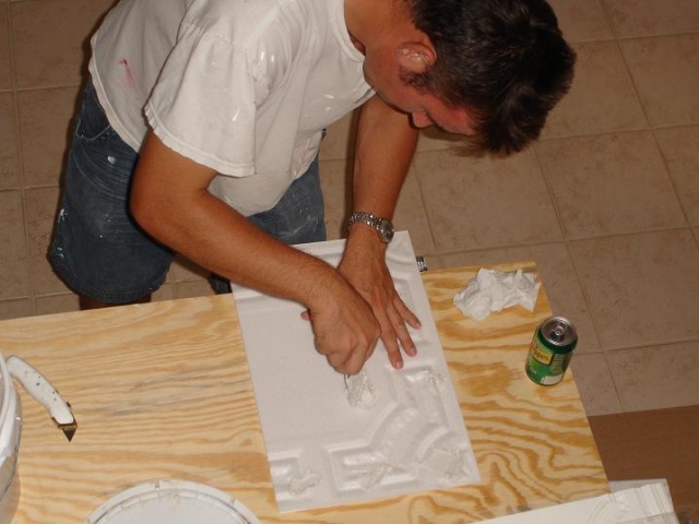 milan jara is applying ceramic tile adhesive on a foam ceiling tile r28 milan jara is applying ceramic tile adhesive on a foam ceiling tile r28.jpg