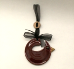Cardinal ornament made in burgundy glaze with black ribbon.