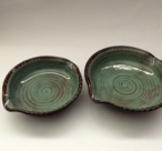 Small and large brie bakers are shown with turquoise glaze inside and turtle shell outside.

