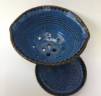 Colander with plate shown with quinn's blue inside and turtle shell outside.