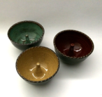 Apple bakers shown here with turquoise, goldenrod and burgundy glazes inside and turtle shell outside.