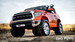 Orange Tundra front driver side view rubber tires