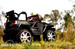 passenger side view black lifted crawler rubber tires