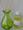 lime green jar with bottle of fragrance