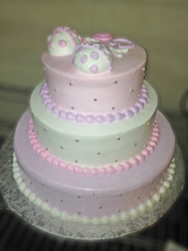 Approximate Servings 80. Sizes: 7", 10" & 14". Three tiered rattle topped cake with silver NON EDIBLE pearls all around.