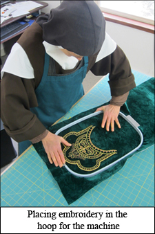 Sister places vestment embroidery inside the hoop for the machine hooping embroidery, vestment embroidery