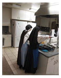Postulant training in kitchen duties Carmelite Postulant