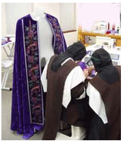 Sisters confront one of the many challenges in sewing the Ash Wednesday cope lenten cope, purple cope