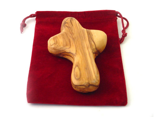 In times of stress, turmoil and uncertainty, it's comforting to have something to hold onto. The Cross is hand-carved in Bethlehem by Christian Artisans. The Olive wood will develop its own patina with time and usage. It is a perfect gift for Him or Her and it makes a perfect companion for prayers or strength. It comes in a velvet pouch with a Certificate of Origin.  Small Cross ~ 2"-3" high. Large Cross ~ 4" high