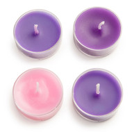 Overhead view of four tea candles in Advent colors arranged in a square.
 