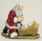 Kneeling Santa with Child Jesus. Materials: Resin/Stone Mix. Dimensions:  12"H x 12"L

 