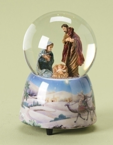 Snow globe with Holy family inside glass globe and a base that features the wise men following the Star of Bethlehem.