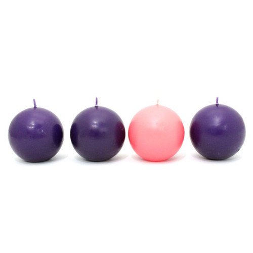 Three purple and one pink ball-shaped Advent candles lined in a row