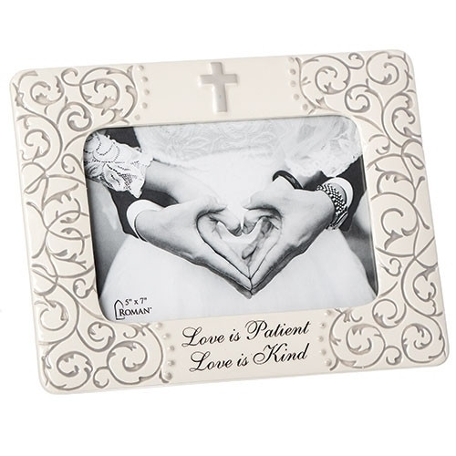 7.75"H Mr. & Mrs. Scroll Frame.  A simple cross adorns the top of the frame, while the bottom of the frame has the wording "Love is Patient, Love is Kind" Scrolling adorns both sides of the frame. Perfect Wedding or Anniversary gift. Holds a 5' x 7" photo. 