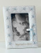 7" Baptism frame for a Boy or Girl, holds a 3.5" X 5" photo. Measures 7"H x 5.5"W x .5"D. Made of Resin/Stone Mix and Glass.