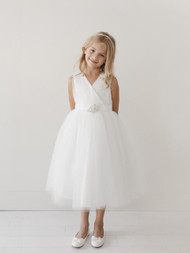 This Communion dress has a V Neckline and a glitter tulle skirt. The dress also comes with a removable rhinestone  brooch. The back has a center zipper and a sash tie back. 
3 dress limit per order