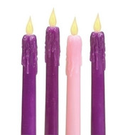 Three purple and one pink battery operated taper candles with detailed wax design dripping from fake flame.