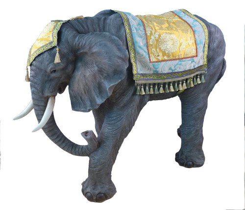 Nativity elephant with intricately detailed headpiece and rug on its back. 