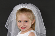 This beautiful veil is made with satin and decorated with pearls for the perfect look. 
The veil includes a built-in face-framing comb that holds it in place.
This veil is designed pearls and satin flower detailing.