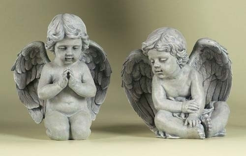 Two angel figures, one kneeling, and one sitting.