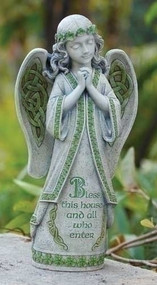 Angel statue with the words “Bless this house and all who enter” inscribed. 