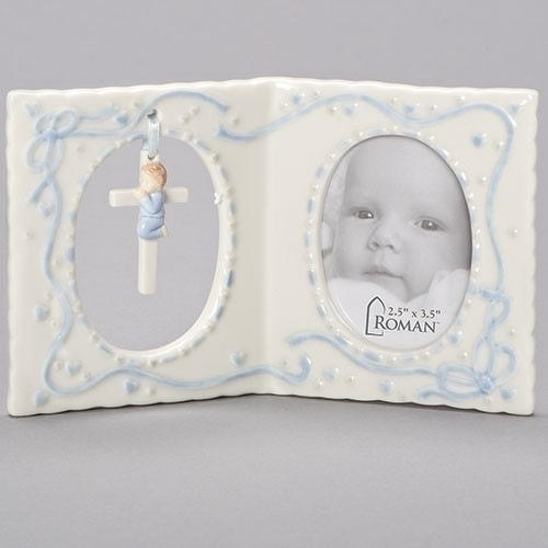 Porcelain Girl(pink) or Boy(Blue) Baby Frame with Cross and holds a 2.5" x 3.5" photo.  Dimensions: 4"H x 6.25"W x 1.237"D. Gift Boxed