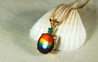 Ammolite Pendant in Gold with Emerald.
