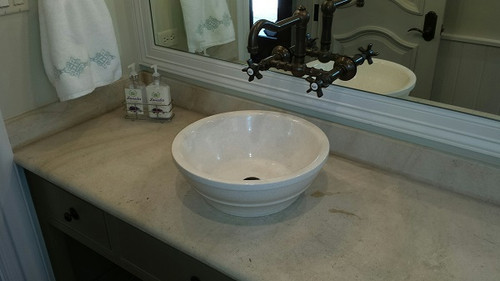 Limestone vessel sink installed