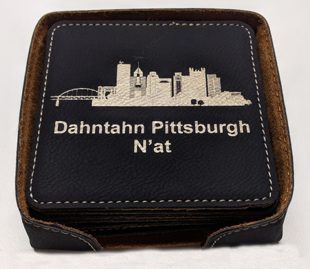 The coasters come in a black leatherette holder 