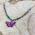 #12.   Purple Butterfly Necklace:   $75
 purple/gold overlay chain
Niobium
• Swarovski crystal
• Bohemian glass
• Gold overlay chain
• Adjustable: 18-20" long
• Drop: 3/4" l. x 1" w
