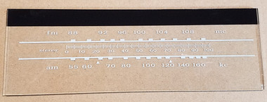 Dial image taken against a tan background to illustrate white print. Dial is clear other than white and black print.