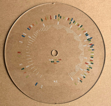 Image taken against a tan/brown background to better illustrate light color portions of dial. The dial is clear other than scale graphics.