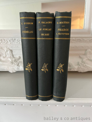 Discover a beautiful three-volume antique French literary set uniformly bound in forest green half-leather with stunning peacock hand-marbled endpapers. Includes Guy Boothby's classic Victorian Gothic thriller Pharos l'Égyptien, making it an exceptional decorative library statement. Antique French Literary Collection