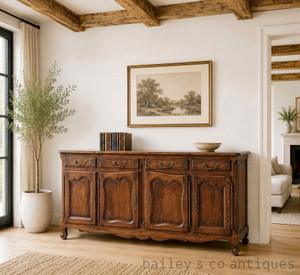 Antique French oak Louis XV style enfilade sideboard featuring four drawers, four cupboards, rich chocolate-brown patina and beautiful oak grain. Authentic French antique furniture.