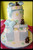 Two tiered, stacked, fondant covered cake. Handcrafted fondant teddy bears, bows and flowers