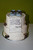 Two tiered, stacked cake. Buttercream covered, Fondant note, chocolate booties and cherubs.