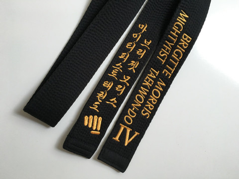Black belt with gold embroidery. This is an example of a belt with 3 additional lines (the fist is considered as an additional line).