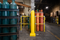 Yellow 6" x 48" Plated Bollard Cover protecting a storage area