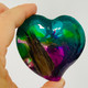 large heart, deep technique using green, cerulean blue, and purple with a lock of hair added