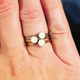 Stainless, gold, and rose gold dot rings shown stacked together.